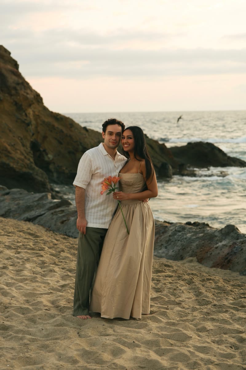Standing together on the beach by the rocks